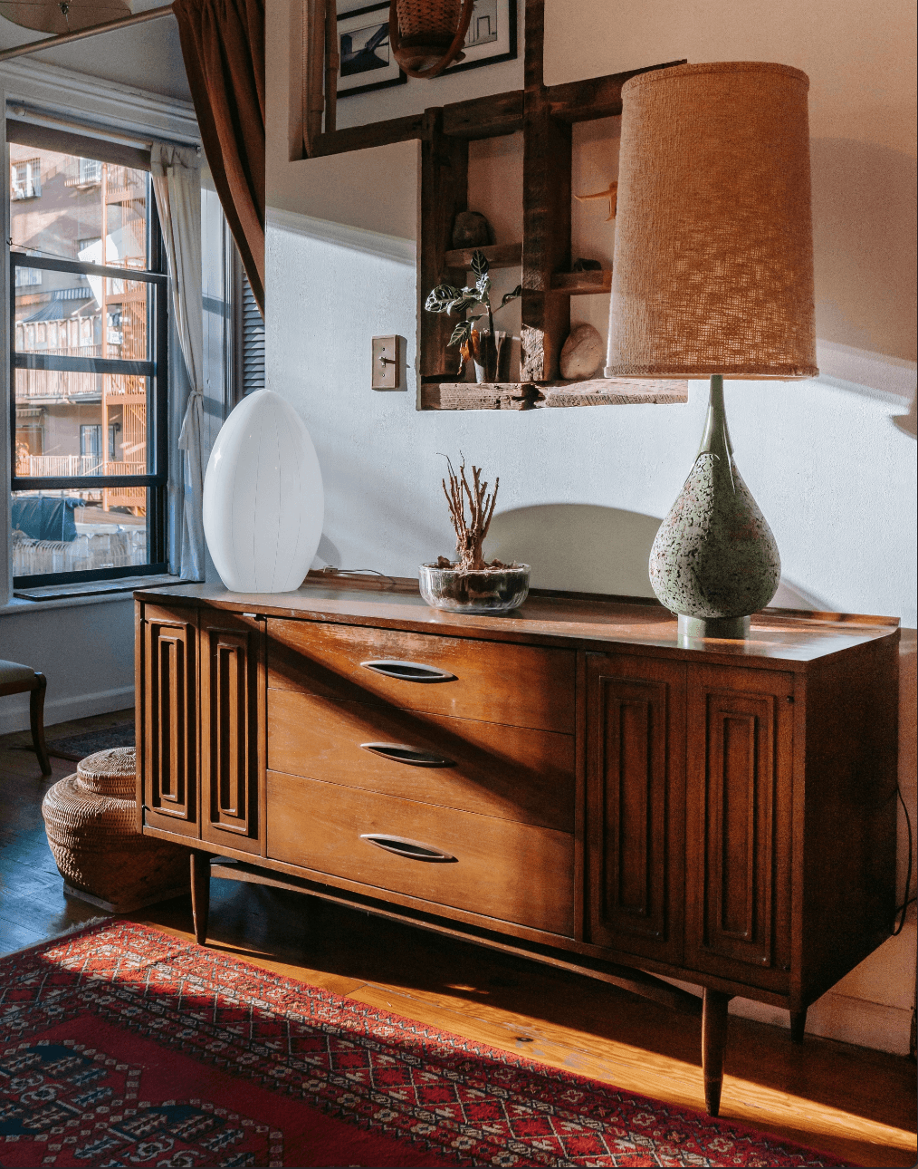 A vintage wooden credenza with brass hardware and tapered legs